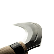 Sickle with wooden handle on a white background